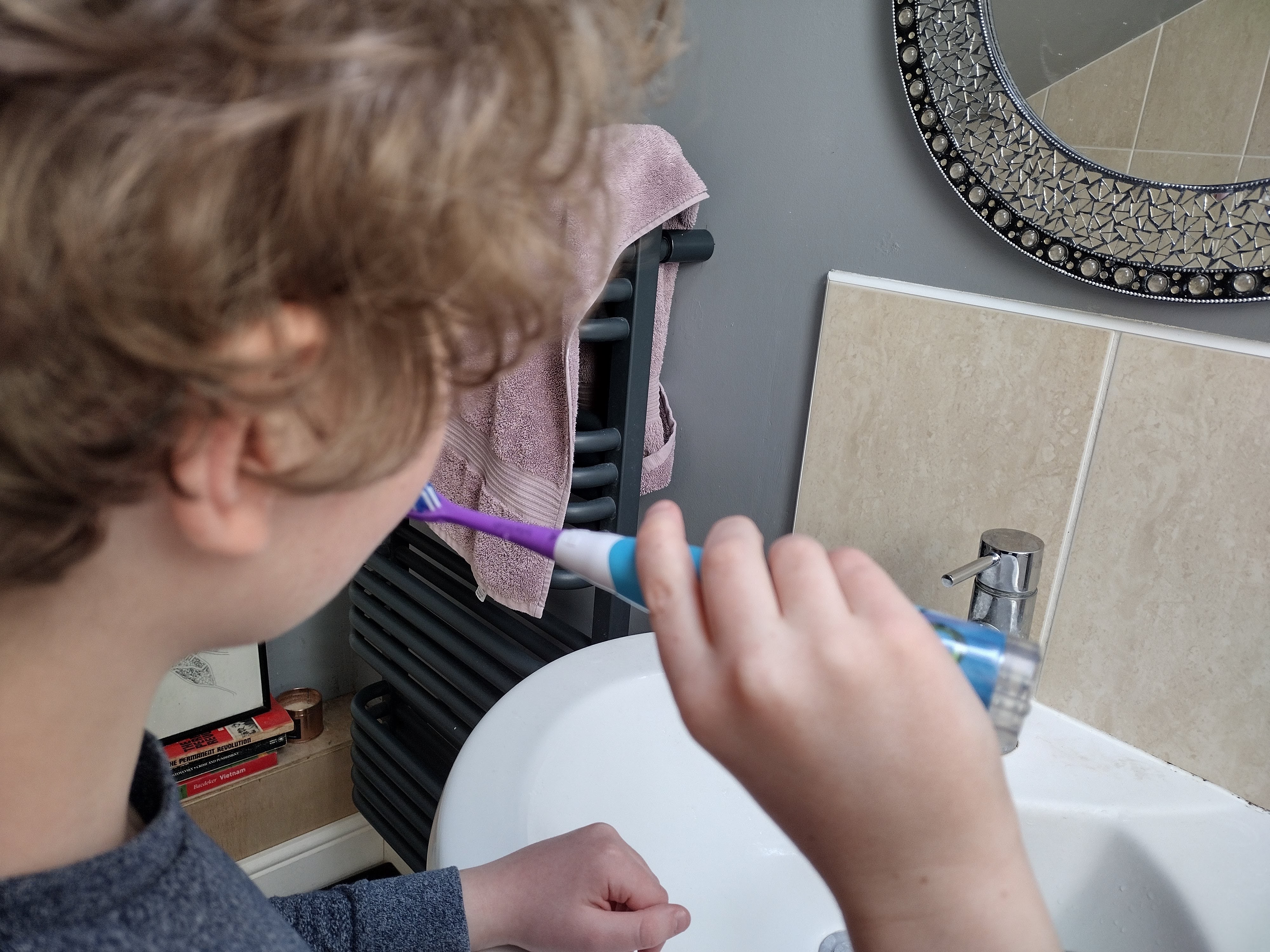 Child using the BriteBrush Games Brush kids electric toothbrush