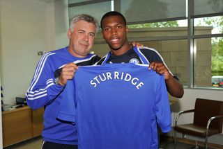 Manager Carlo Ancelotti presents new signing Daniel Sturridge of Chelsea with his shirt before his press conference at the Cobham training ground on July 9, 2009 in Cobham, Surrey. (Photo by Darren Walsh/Chelsea FC via Getty Images)