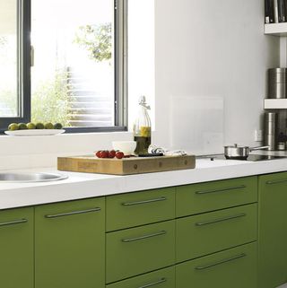 Kitchen with white walls and green cabinet