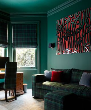 Color drenched green living room with green tartan couch