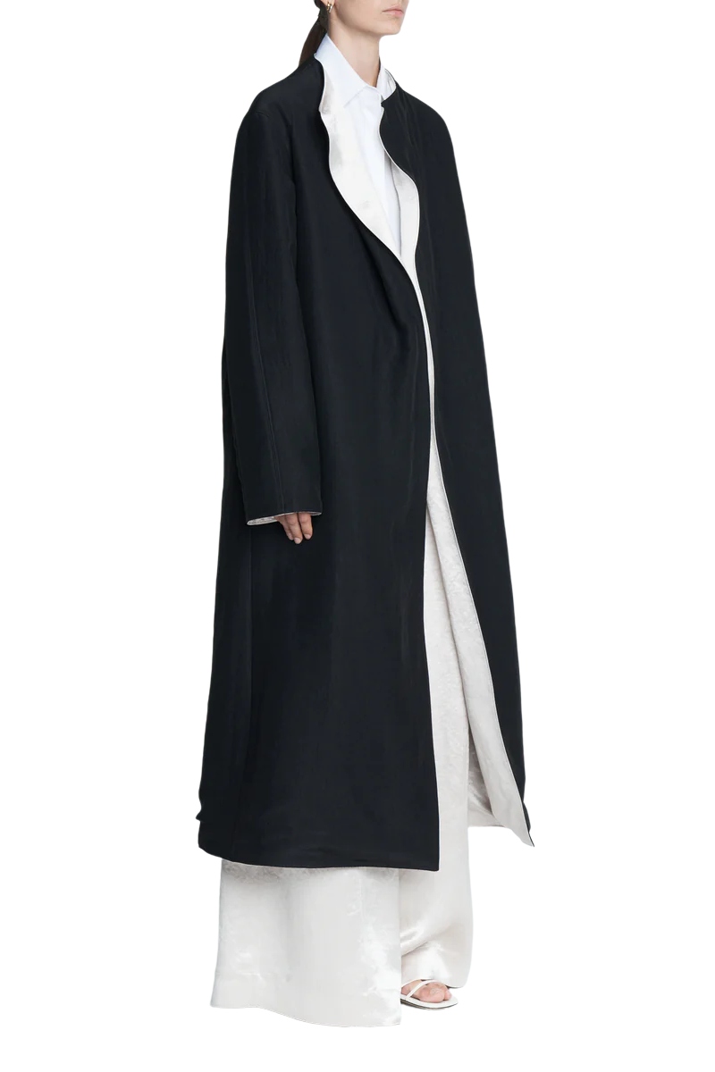 Silky black duster coat with reversible white collar.