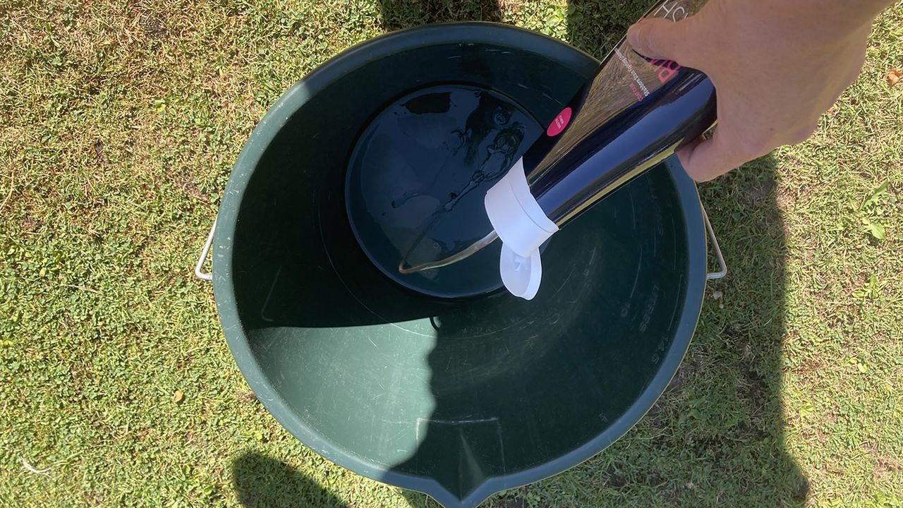 Putting shampoo in bucket