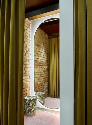 Brick and green curtained dressing room