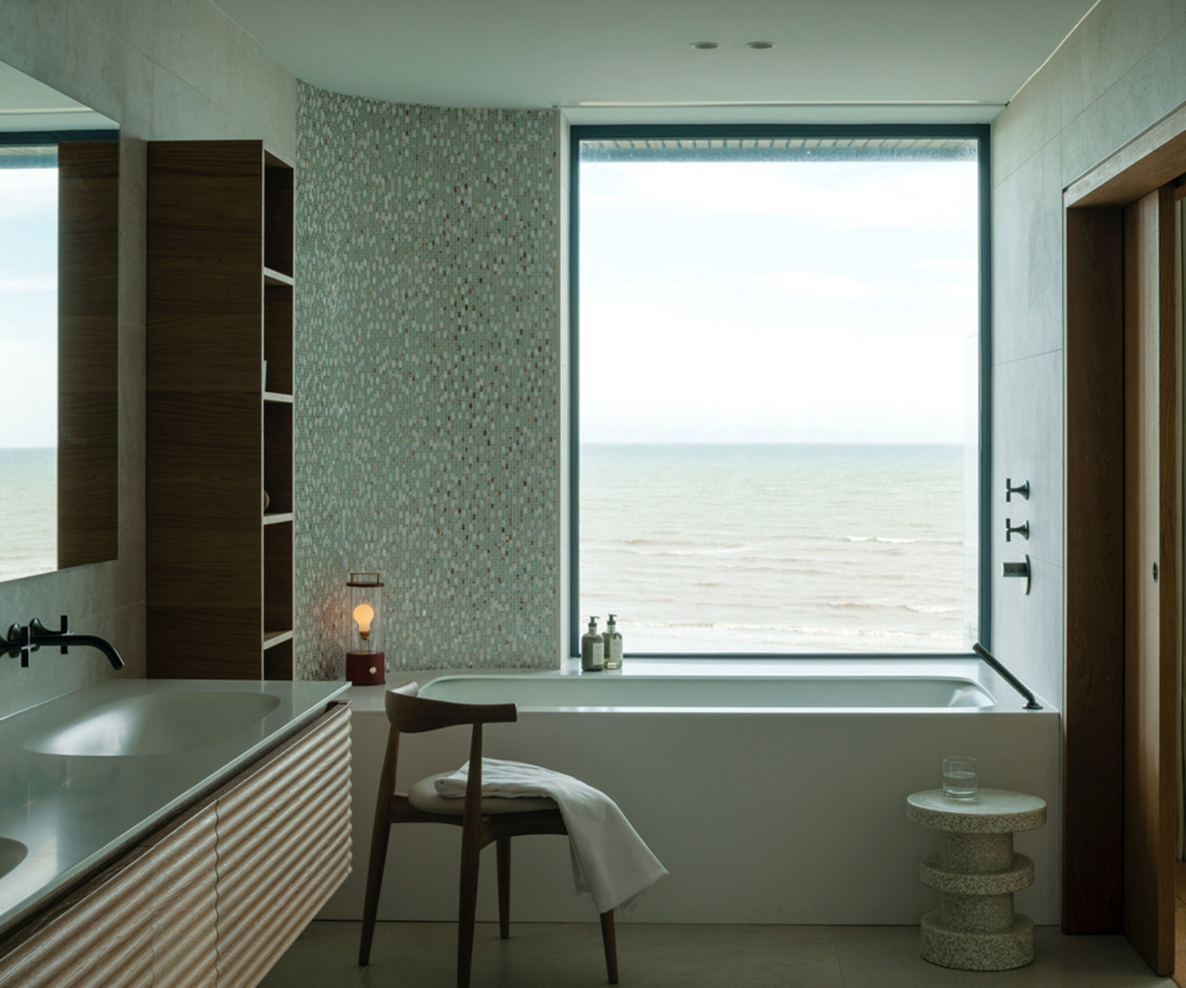 modern bathroom with picture window next to bath