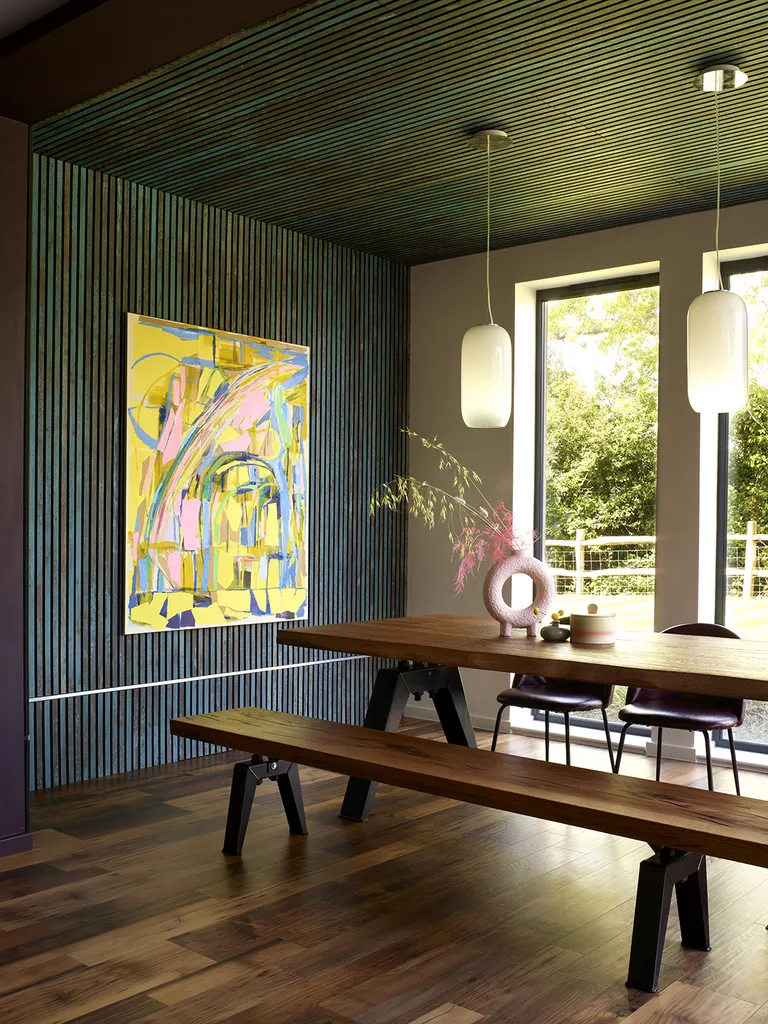 minimalist dining room with wood clad walls and modern art