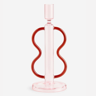 A pink candlestick with red handles