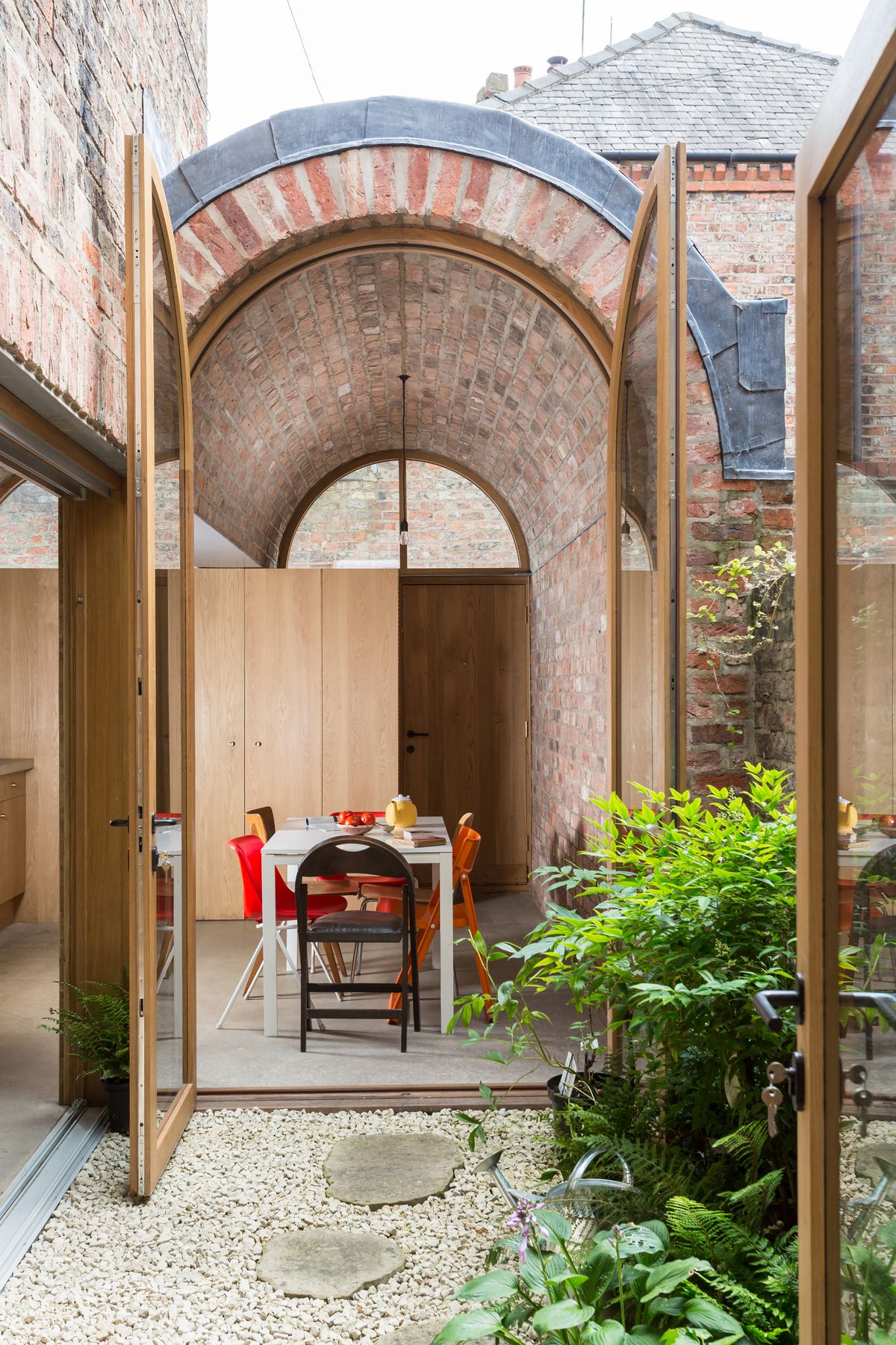 dining room with barrel vaulted ceiling and patio doors
