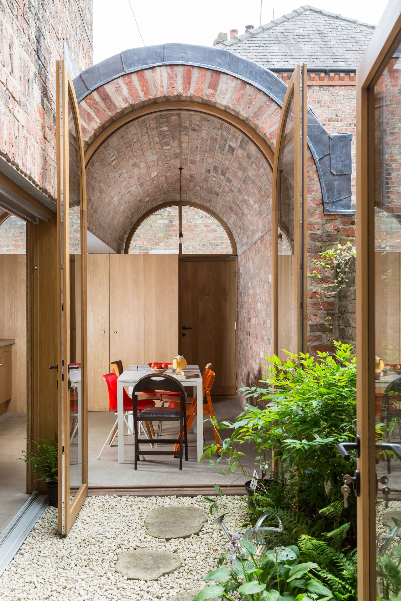 dining room with barrel vaulted ceiling and patio doors