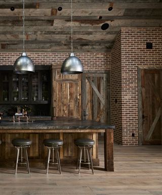 An industrial kitchen with brick walls and a wooden ceiling