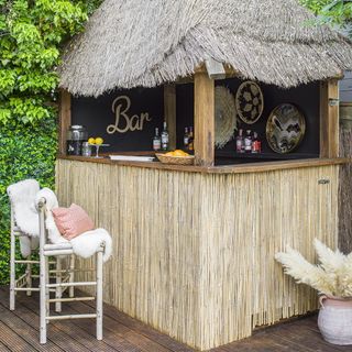 bamboo bar hut with table vase and chairs
