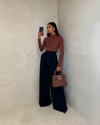 An image of an Jasmine Tookes wearing an Hermès Birkin.