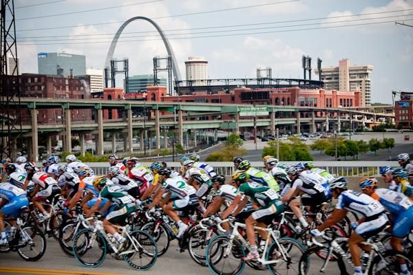 The bunch goes by the silhouette of the St. Louis skyline.