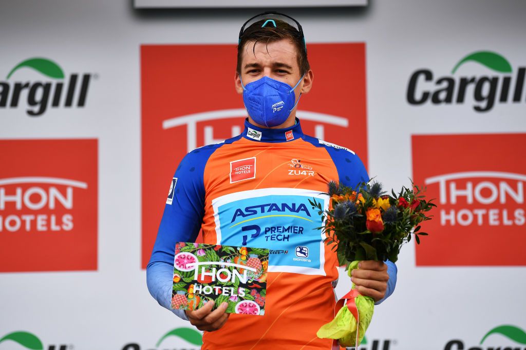 TROMSO NORWAY AUGUST 05 Gleb Brussenskiy of Kazahkstan and Team Astana Premier Tech Salmon Mountain Jersey celebrates at podium during the 8th Arctic Race Of Norway 2021 Stage 1 a 1425km stage from Troms to Troms ArcticRace on August 05 2021 in Tromso Norway Photo by Stuart FranklinGetty Images