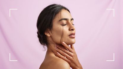 What is dermaplaning? A model touching her smooth skin on a pink backdrop