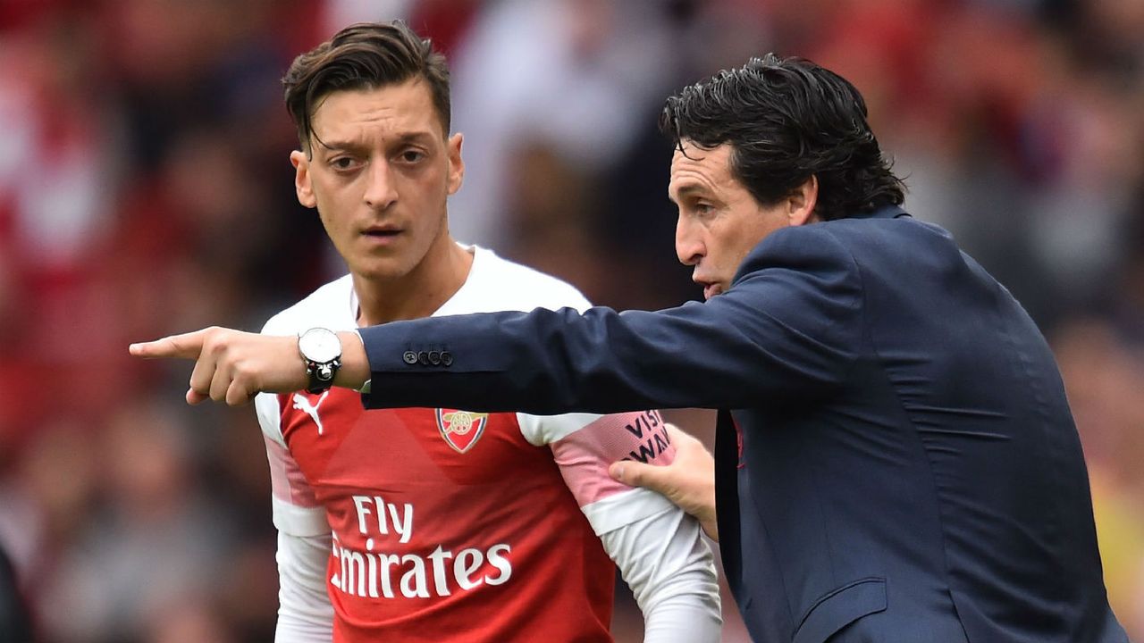 German midfielder Mesut Ozil receives instructions from Arsenal head coach Unai Emery