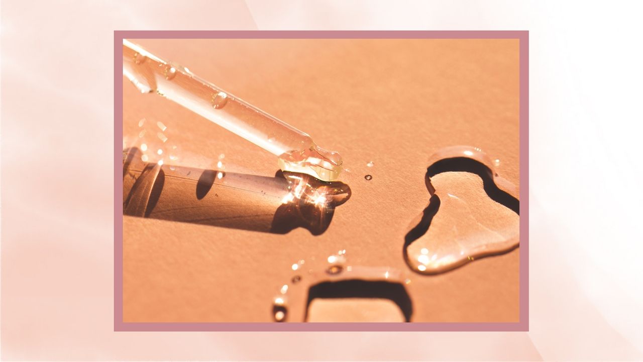 A clear glass pipette is pictured on an orange background alongside drops of clear, serum-like liquid/ in pink watercolour gradient template