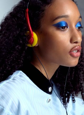 Electric blue graphic Chanel eyeshadow on girl with retro headphones