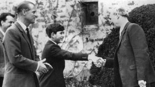 Prince Charles greets Robert Chew, the headmaster of Gordonstoun School, on his first day as a pupil
