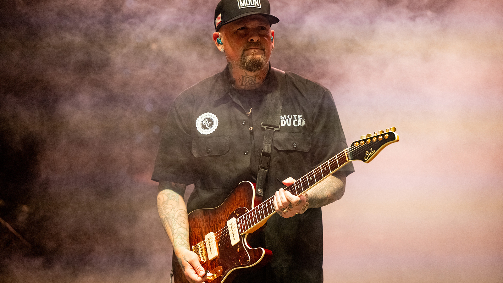 Benji Madden performing with a Suhr guitar on stage