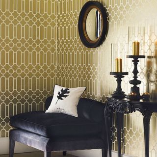 living room with black round mirror on printed golden walls