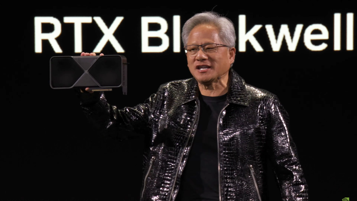 Nvidia CEO Jensen Huang holding an RTX 50-series card.