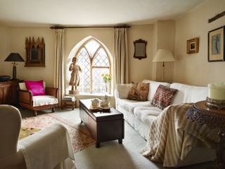 living room with arch windows sofas, rugs and lamps