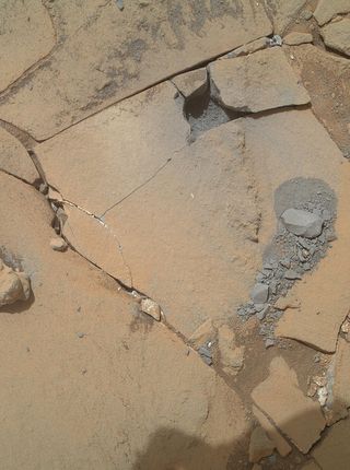 This photo, taken on Jan. 13, 2015 by the Mars Hand Lens Imager on NASA's Curiosity rover, shows the results of a mini-drill test to assess whether the "Mojave" rock is appropriate for sample-collecting drilling.