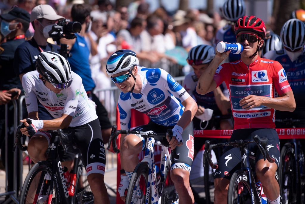From L Team UAE Emirates Spanish rider Juan Ayuso wearing the best youths white jersey Team AlpecinDeceunincks Australian rider Jay Vine wearing the best climbers jersey and Team Quick Steps Belgian rider Remco Evenepoel wearing the overall leaders red jersey wait to take the start of the start of the 16th stage of the 2022 La Vuelta cycling tour of Spain a 1894 km race from Sanlucar de Barrameda to Tomares on September 6 2022 Photo by JORGE GUERRERO AFP Photo by JORGE GUERREROAFP via Getty Images