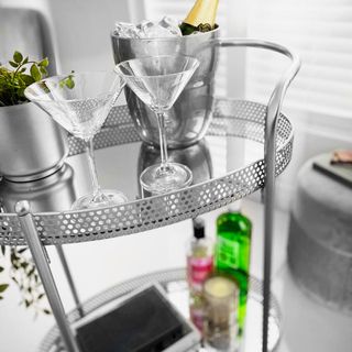 Drinks trolley with cocktail glasses and ice bucket