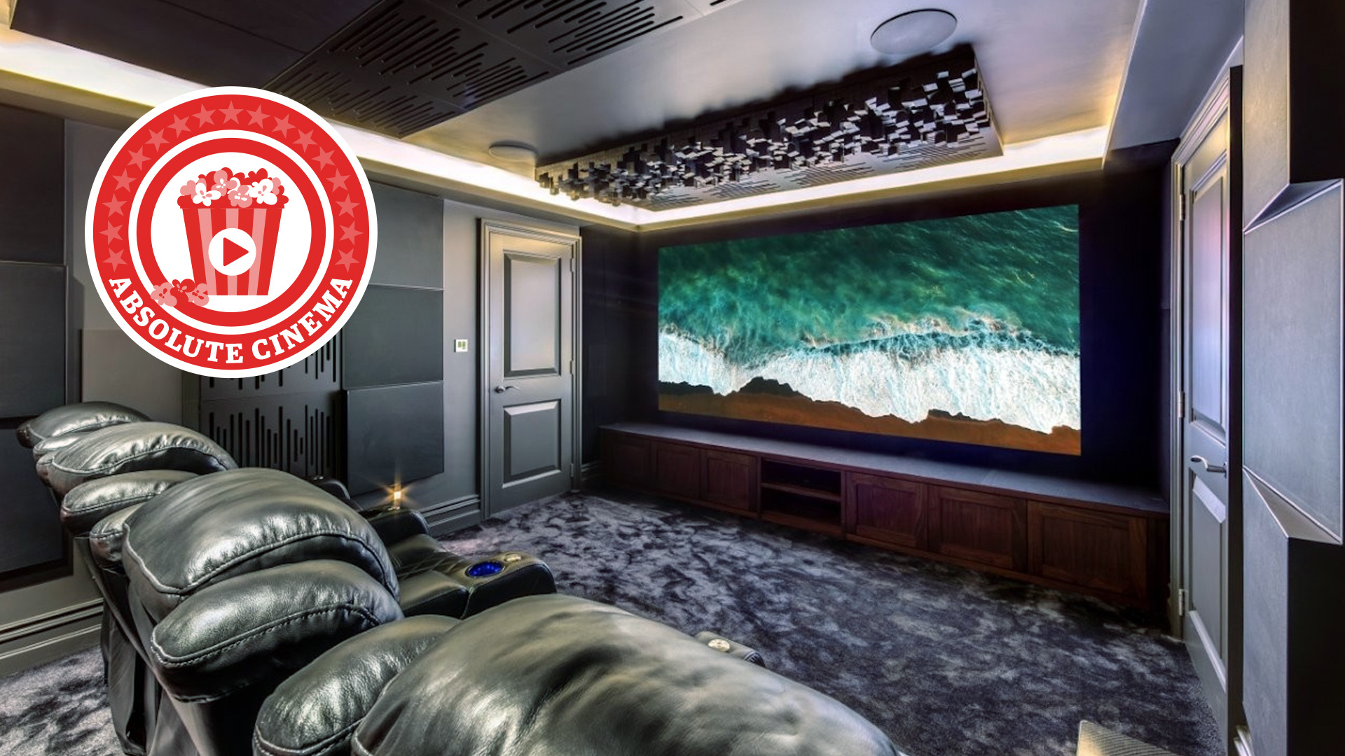 A photo of a custom-installed home cinema room featuring a 4K projector, theatre seating and clever acoustic treatment