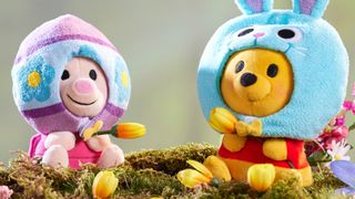Piglet and Winnie the Pooh in Easter outfits on a mossy log