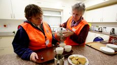 NORTH PETHERTON, UNITED KINGDOM - FEBRUARY 05:RVS volunteers Verity Trevor-Morgan and Marsha Casely make cups of tea at a rest centre that has been set up at North Petherton bowling club for 