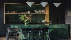A kitchen island in green marble stone