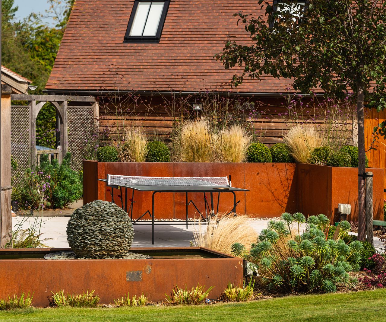 Corten steel raised planters in a landscaped garden