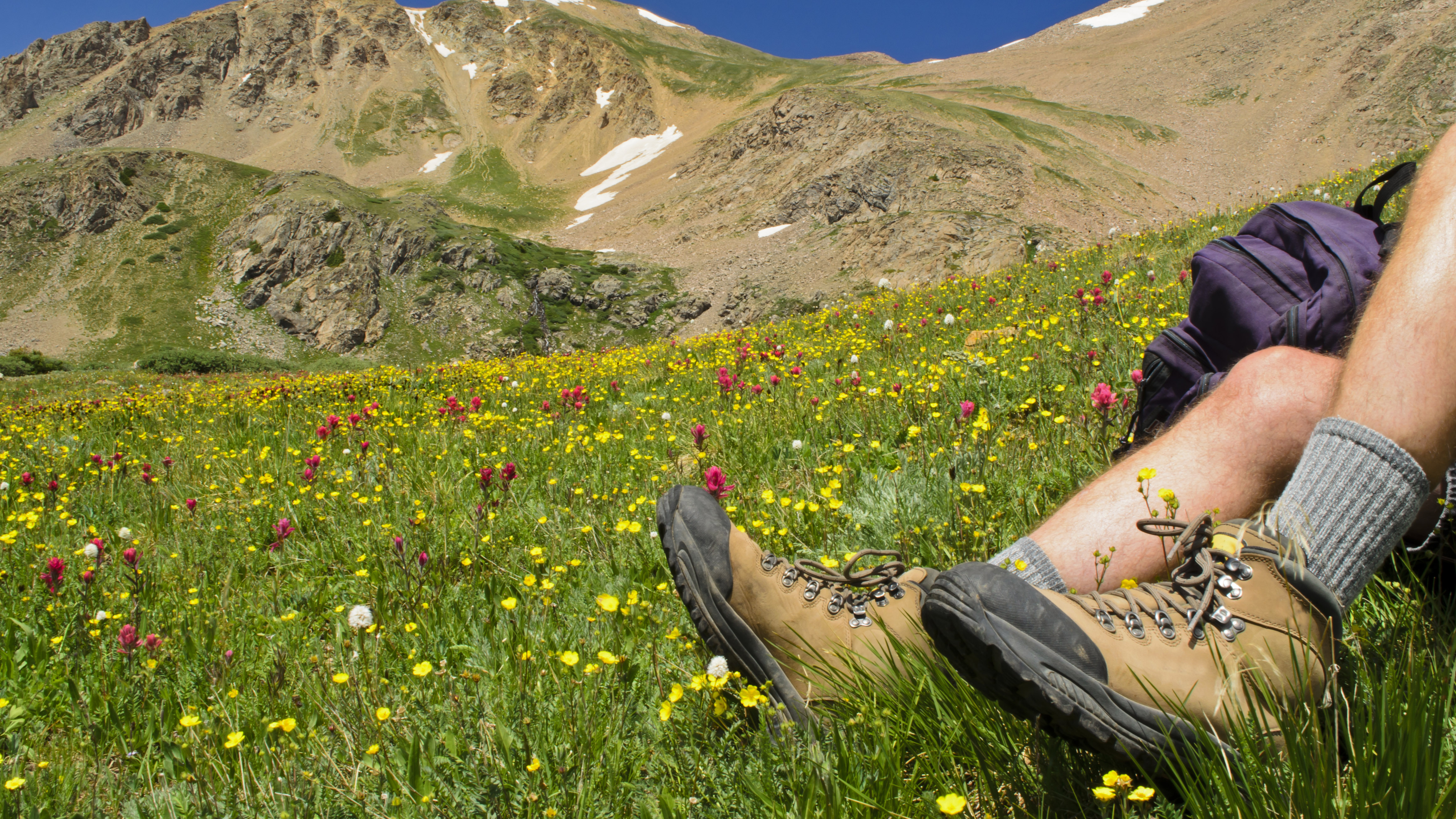 A hiker wearing hiking socks and boots taking a break