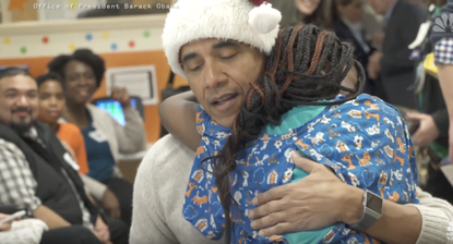 Barack Obama hugs a child in the hospital.