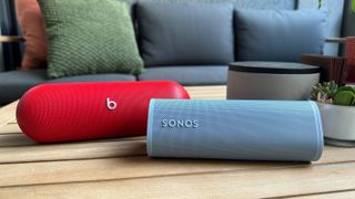 Beats Pill speaker in red and Sonos Roam 2 speaker in blue