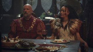 Dijkstra and Philippa chat as they sit at a fancy table in The Witcher season 3