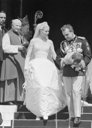 Grace Kelly and Prince Rainier of Monaco, shown here waving to the crowds from the Monaco Royal Palace after the magnificent wedding in the Cathedral of St. Nicholas in 1956