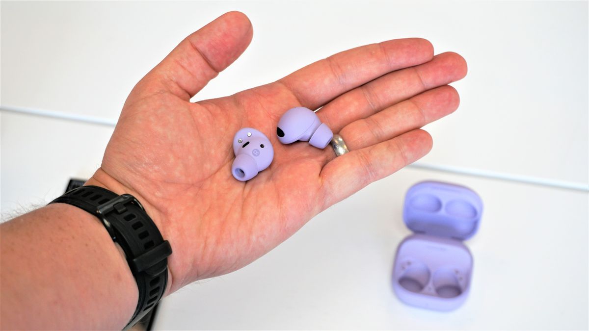 Two galaxy buds 2 pro in hand, purple