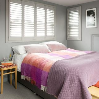 bedroom with venetian blind window and grey walls