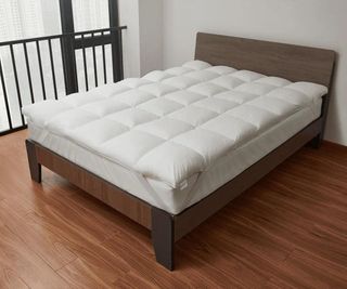 Coop Retreat Mattress Topper on a wooden bed frame.