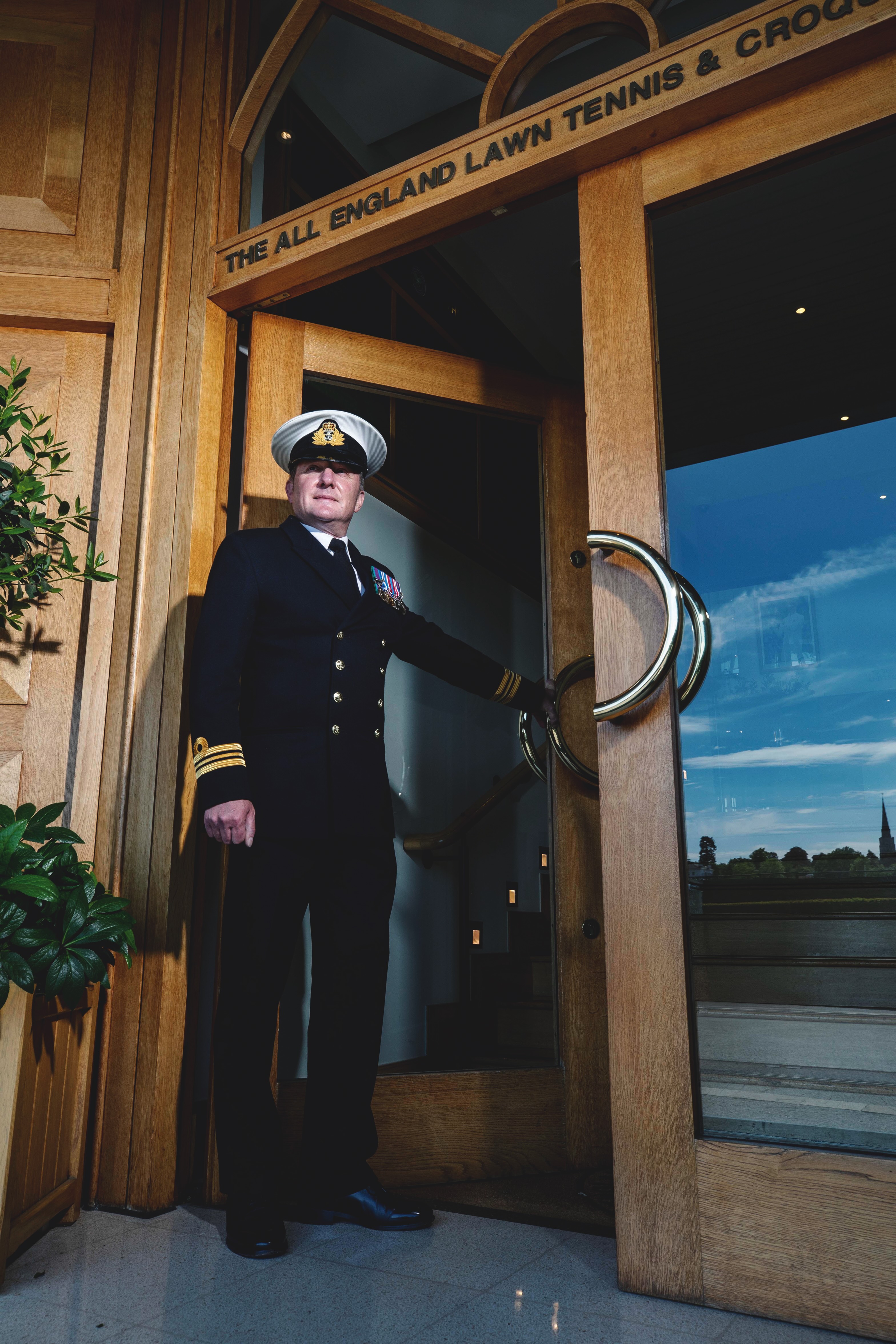 Christopher Boucher, Military Steward. Lt. Cmdr. photographed in front of clubhouse.