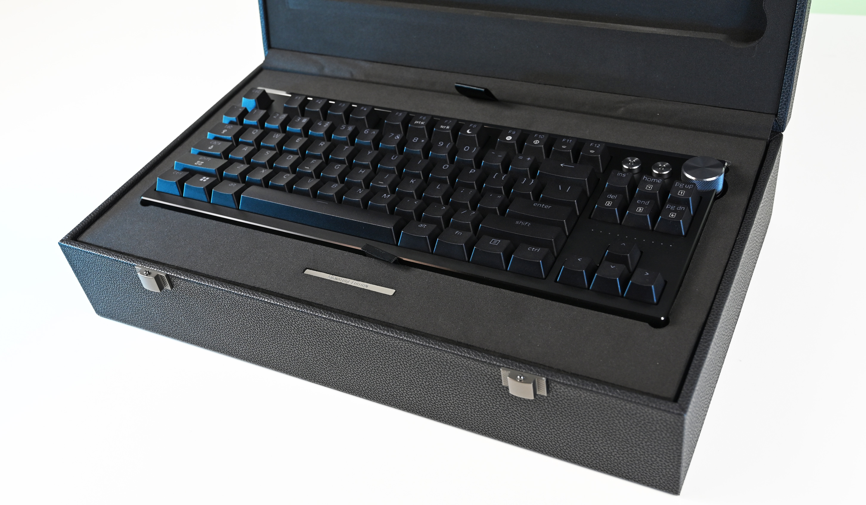 The Razer mechanical keyboard nestled securely inside its custom-molded, foam-padded black presentation box with the lid open.