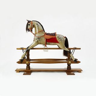 rocking horse with stand and dapple grey color