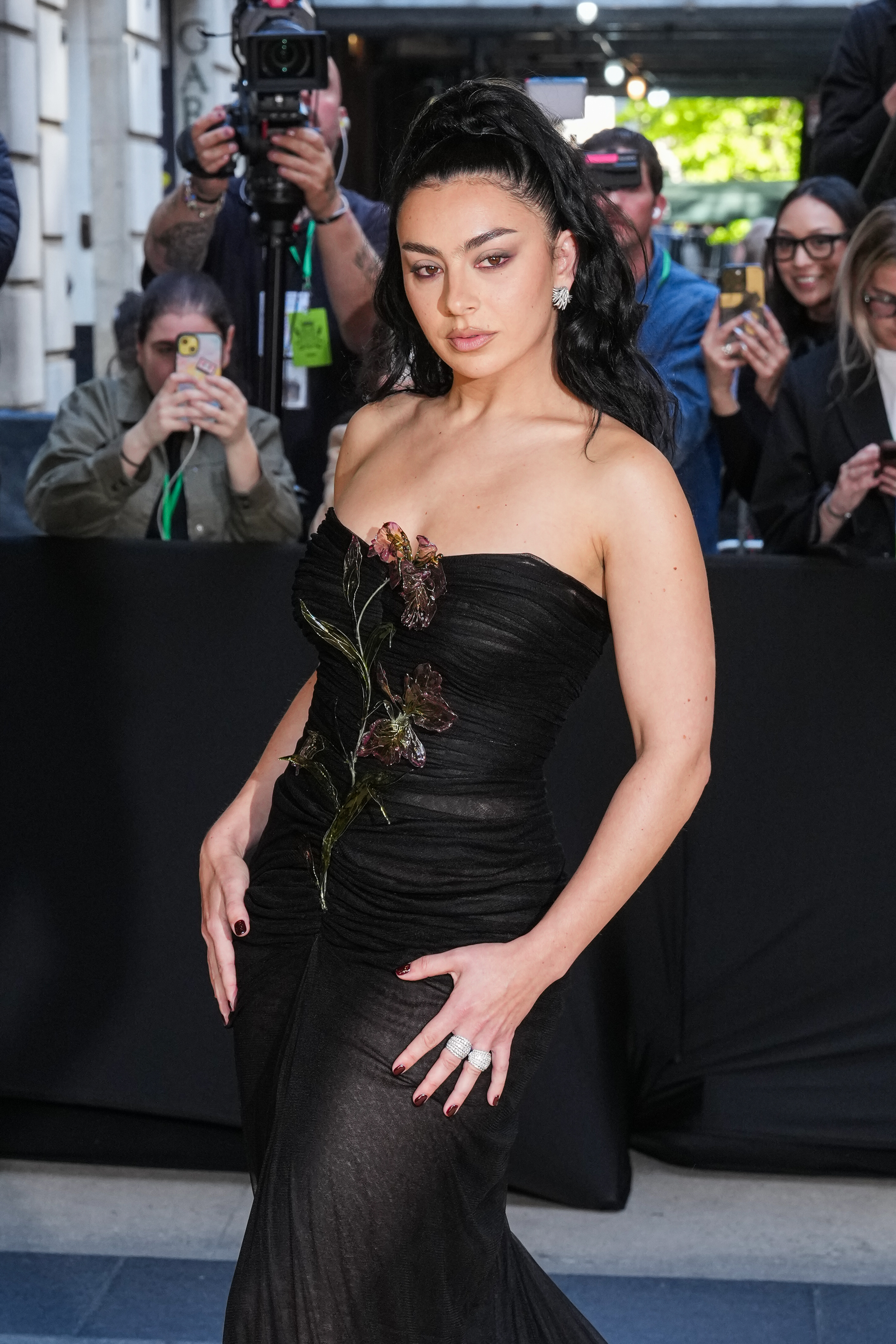 a woman with dark brown hair in a black gown