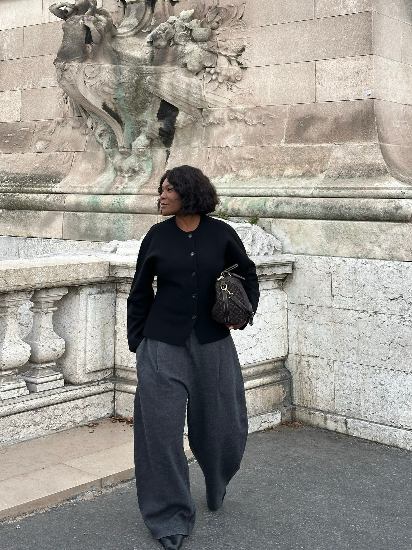 French woman with a collarless jacket.