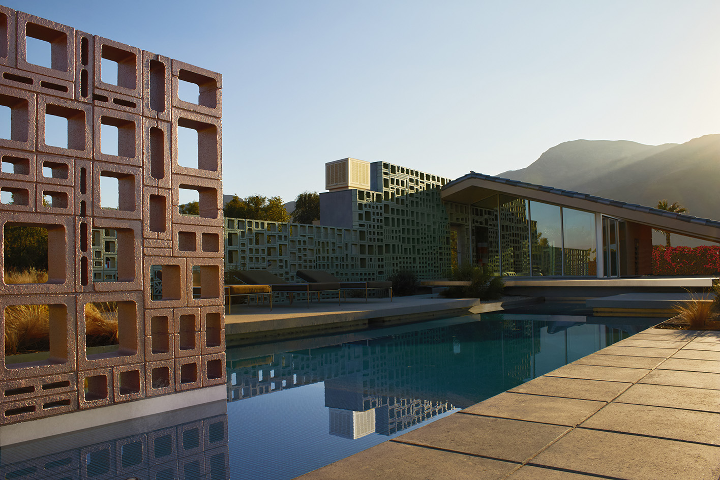 Desert house by Robert Stone, a home made with perforated partitions and an intense pitched low roof