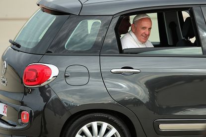 Pope Francis in a Fiat 500L.