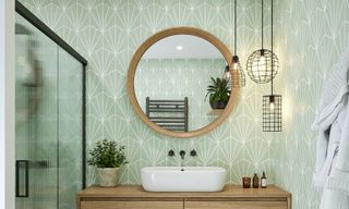 Round mirror on bathroom wall with basin and green tiles